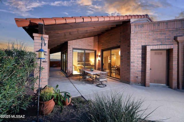 view of patio terrace at dusk