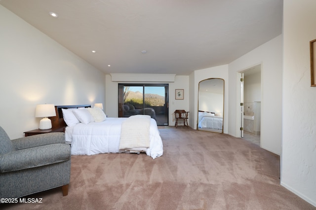 bedroom featuring access to outside, arched walkways, ensuite bathroom, and light colored carpet