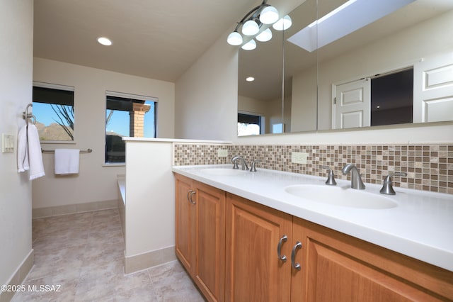 bathroom featuring vanity and tasteful backsplash