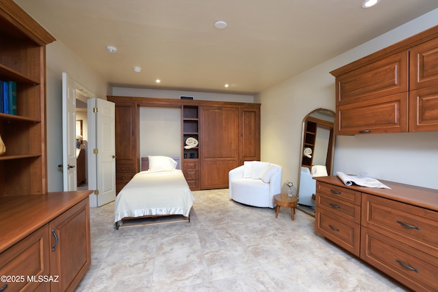 bedroom with arched walkways, visible vents, and recessed lighting