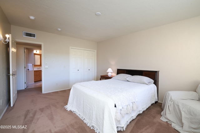 bedroom featuring carpet, a closet, visible vents, and baseboards