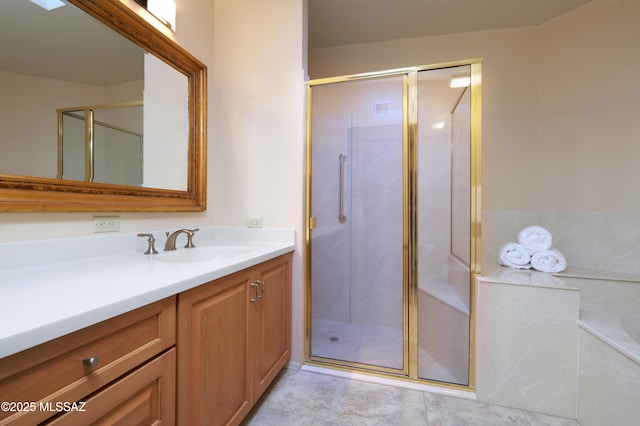 bathroom with walk in shower and vanity