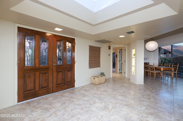 entrance foyer with a tray ceiling