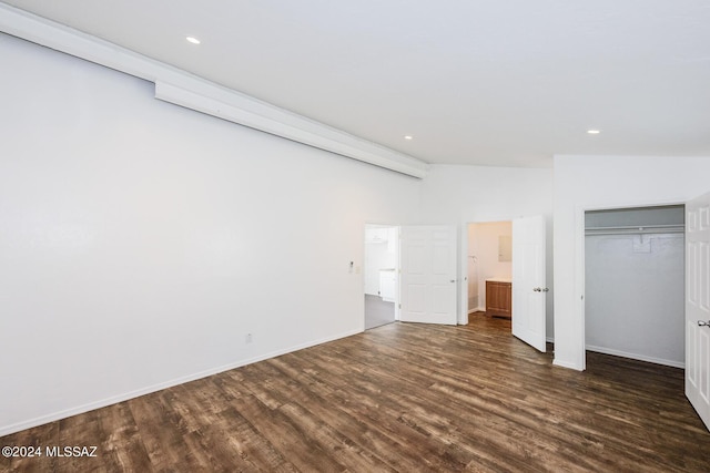 unfurnished bedroom with high vaulted ceiling, a closet, and dark hardwood / wood-style floors