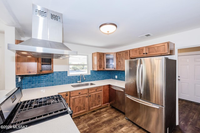 kitchen featuring island exhaust hood, decorative backsplash, dark hardwood / wood-style flooring, appliances with stainless steel finishes, and sink