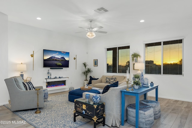 living room with ceiling fan and wood-type flooring