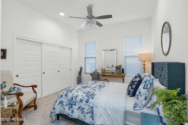 bedroom with carpet, ceiling fan, and a closet