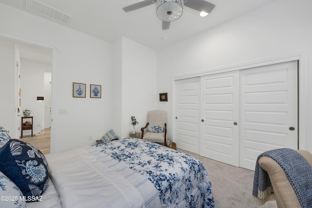 bedroom with light carpet, a closet, and ceiling fan