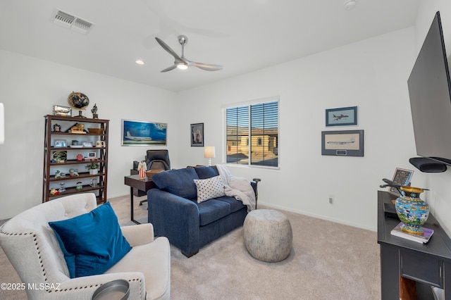 carpeted living room featuring ceiling fan