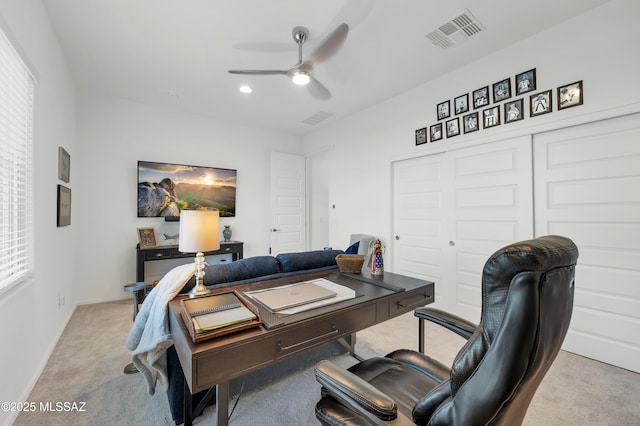 office space featuring light carpet and ceiling fan