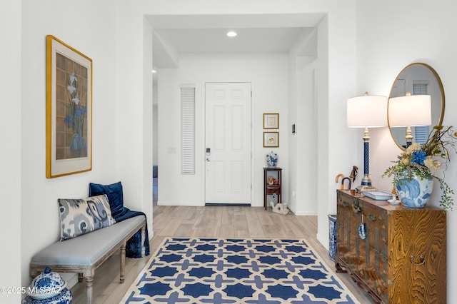 entryway with hardwood / wood-style floors