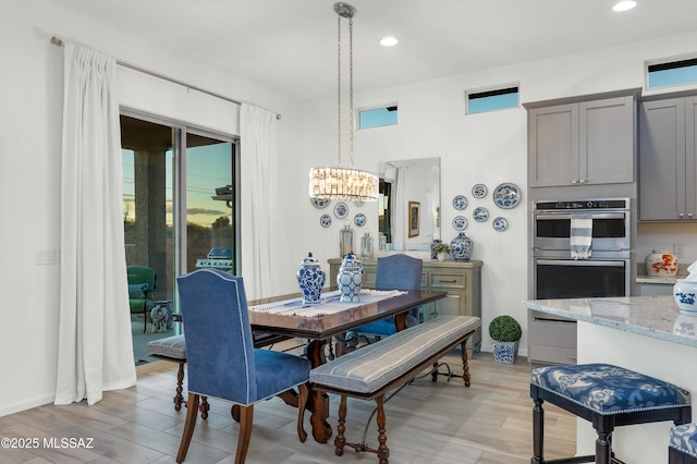 dining space with a healthy amount of sunlight and an inviting chandelier