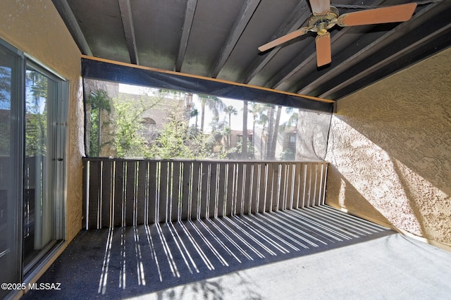 unfurnished sunroom featuring ceiling fan