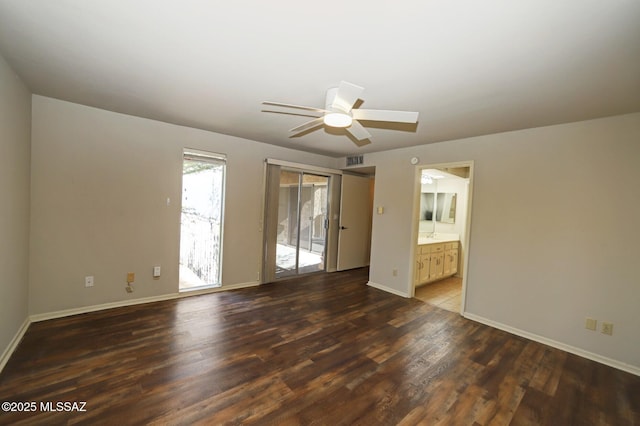 spare room with ceiling fan and dark wood-type flooring