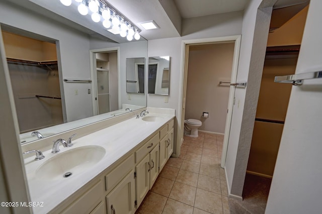 bathroom featuring vanity, tile patterned floors, and toilet