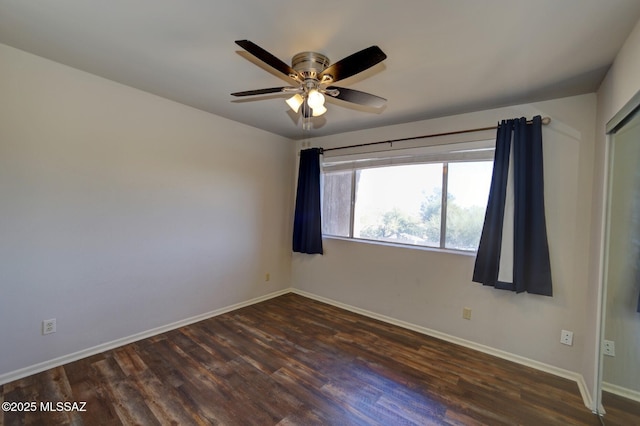 empty room featuring dark wood-type flooring and ceiling fan