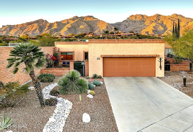 view of front of property featuring a garage and a mountain view