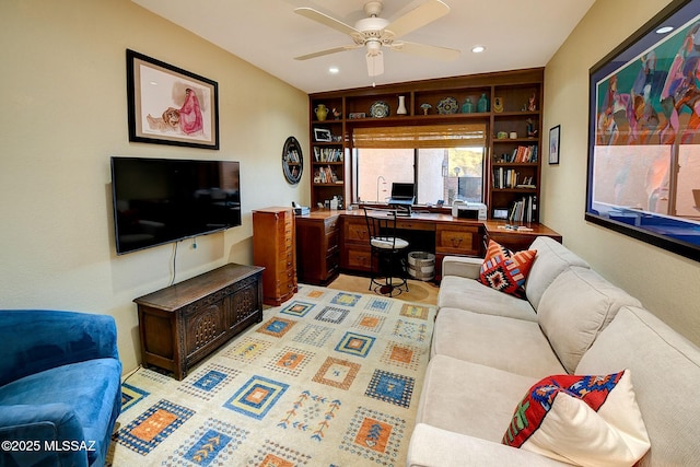 living room with built in features and ceiling fan