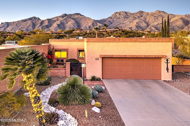 southwest-style home featuring a garage and a mountain view