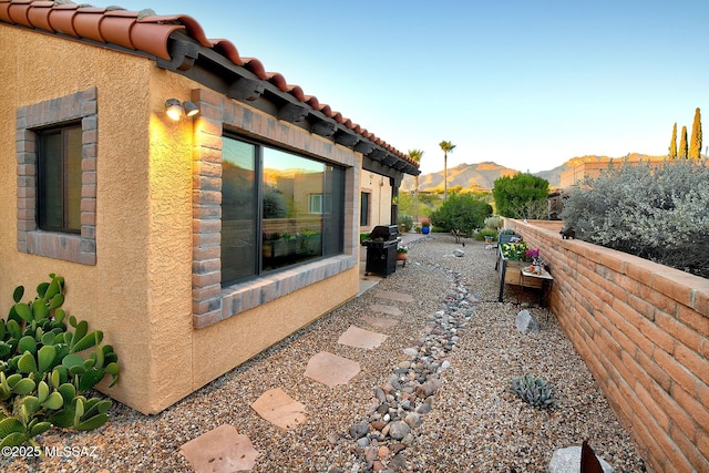 view of side of home with a mountain view