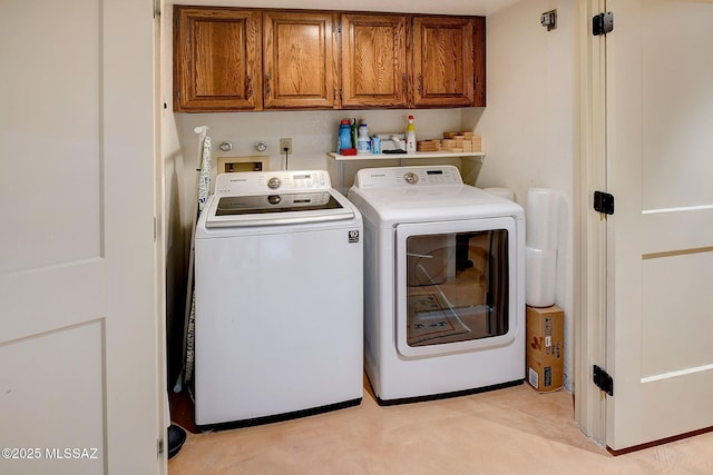 washroom featuring cabinets and separate washer and dryer