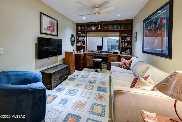 living room featuring built in shelves and ceiling fan