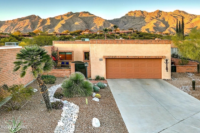 view of front of house featuring a garage and a mountain view