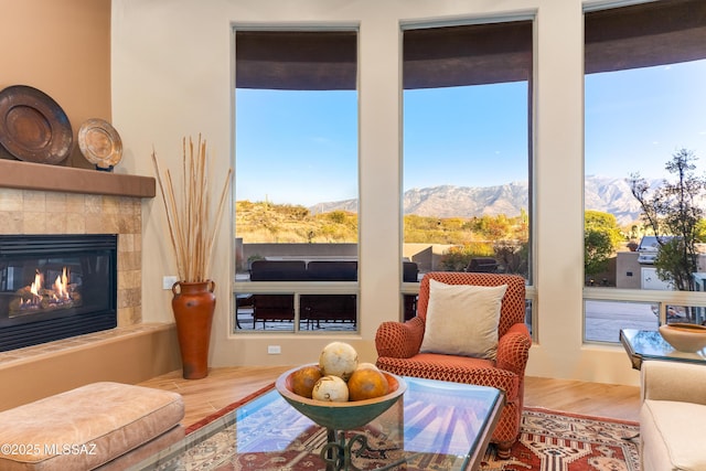 sunroom / solarium featuring a fireplace and a mountain view