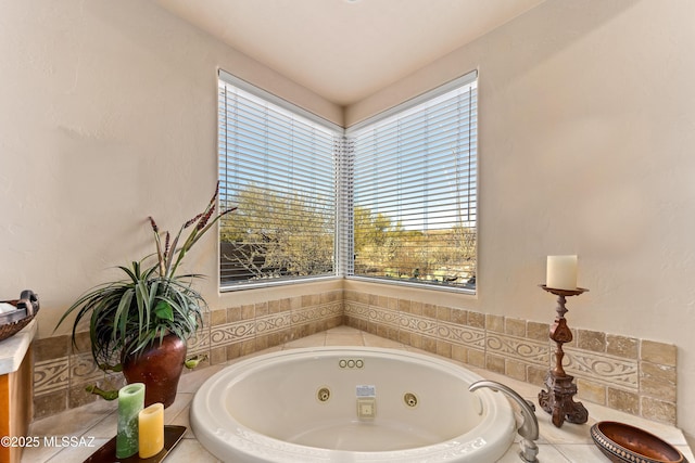 bathroom featuring tiled bath and a healthy amount of sunlight