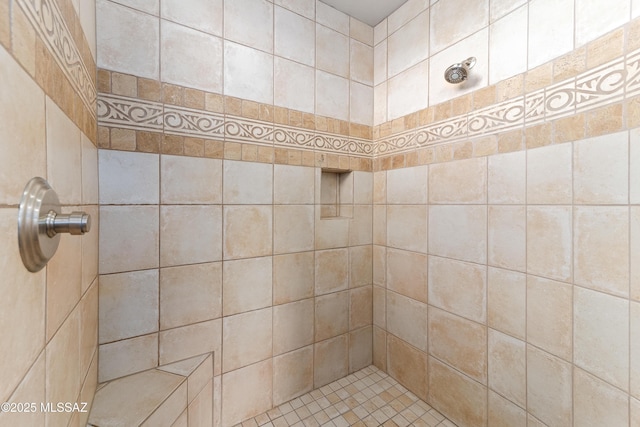 bathroom with tiled shower