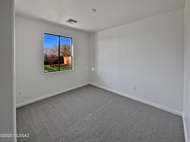 unfurnished bedroom featuring baseboards, multiple windows, visible vents, and light colored carpet