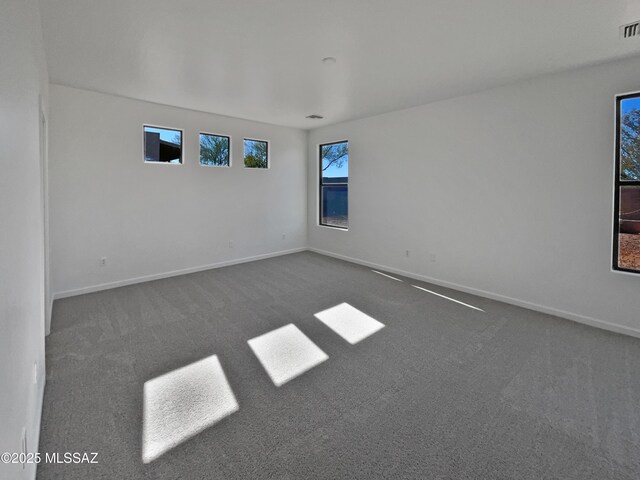 unfurnished bedroom featuring light carpet, a closet, visible vents, and baseboards