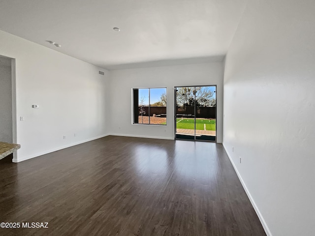 empty room featuring dark hardwood / wood-style flooring