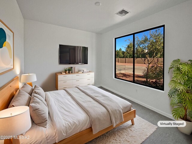 carpeted bedroom featuring baseboards and visible vents