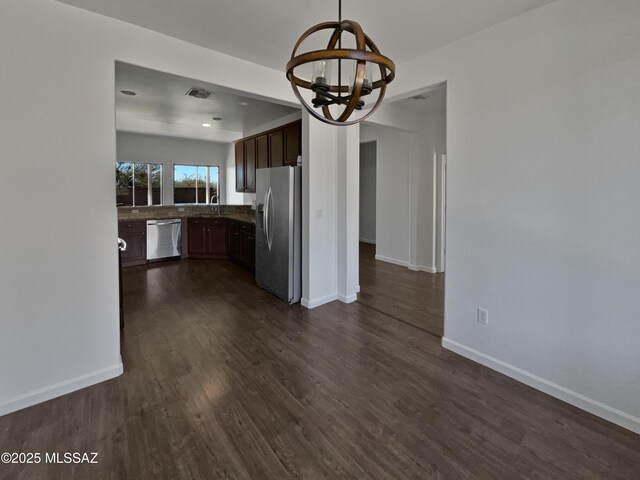 empty room featuring light carpet and baseboards