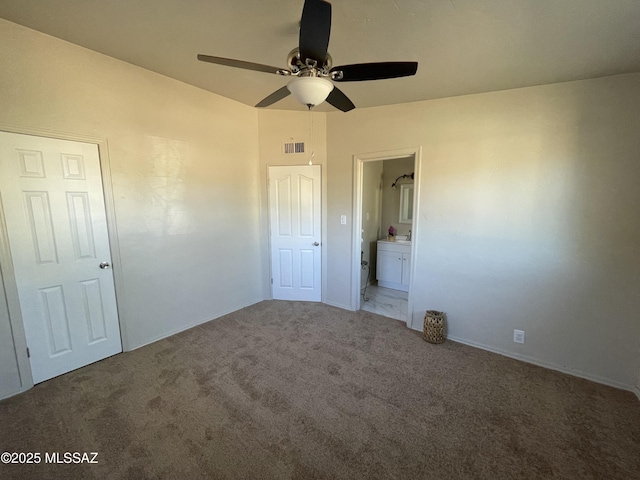 unfurnished bedroom with connected bathroom, ceiling fan, and carpet