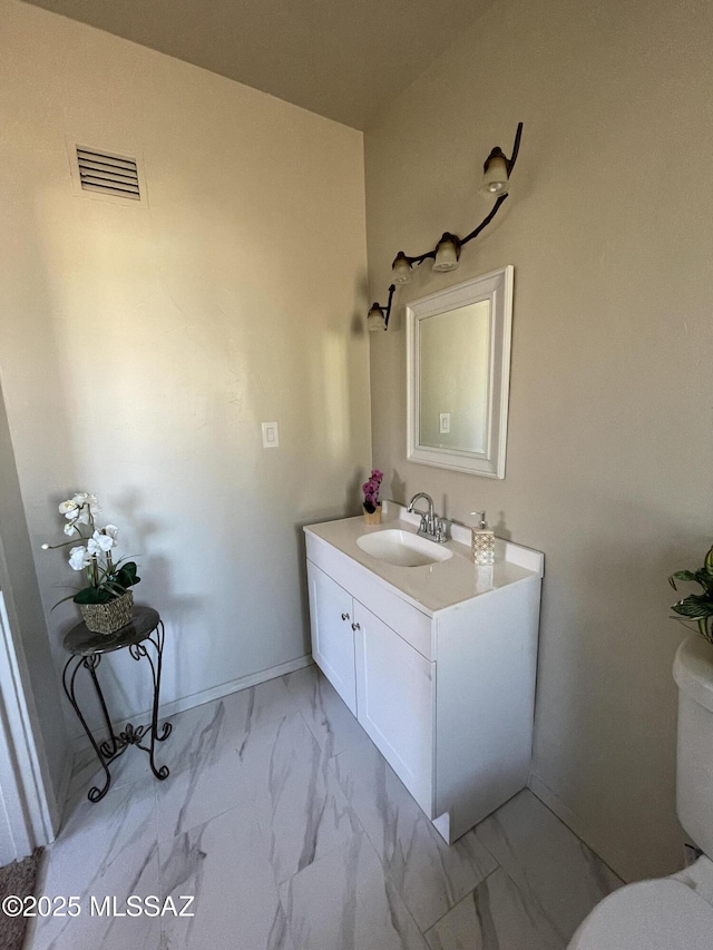 bathroom with vanity and toilet