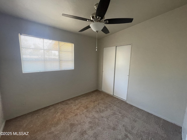 unfurnished bedroom with light carpet, a closet, and ceiling fan