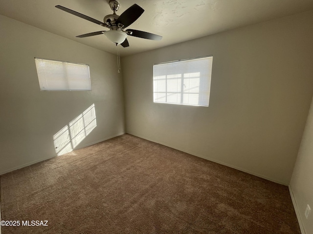 empty room with ceiling fan and carpet