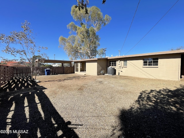 rear view of property with central AC