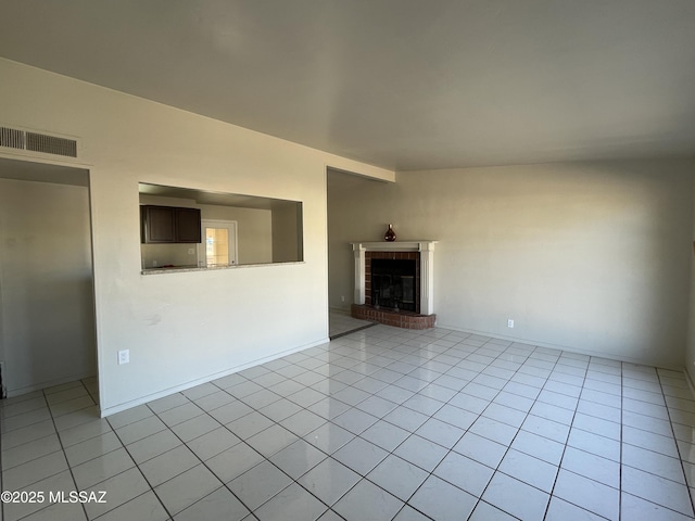 unfurnished living room featuring light tile patterned floors and a fireplace