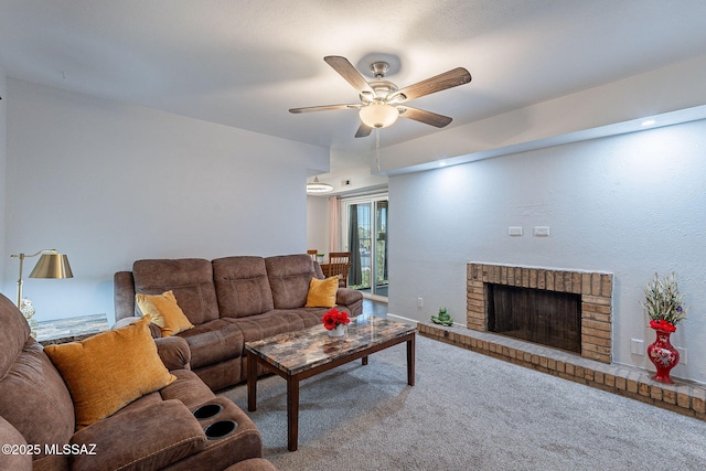 carpeted living room featuring a brick fireplace and ceiling fan