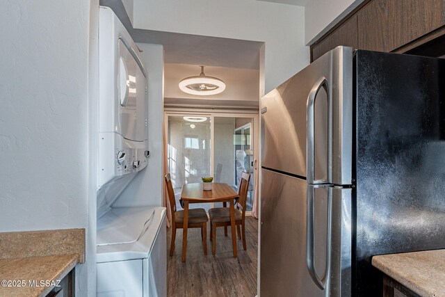 kitchen featuring stainless steel dishwasher, dark brown cabinets, and sink