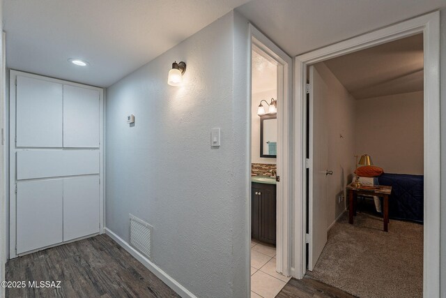 bathroom with a textured ceiling, tile patterned flooring, tile walls, toilet, and vanity