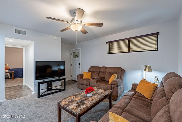 living room featuring hardwood / wood-style floors and ceiling fan