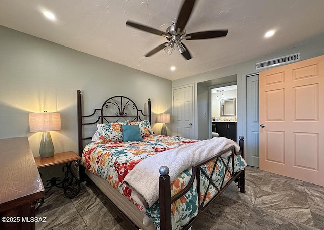 bedroom with ceiling fan and ensuite bath