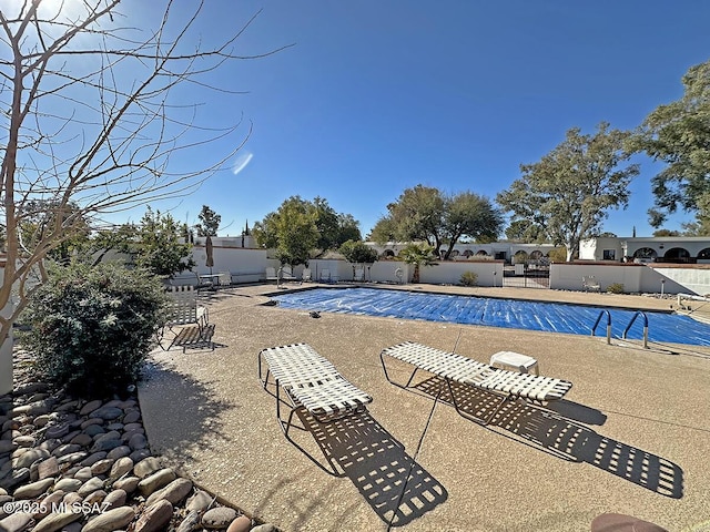 view of swimming pool with a patio