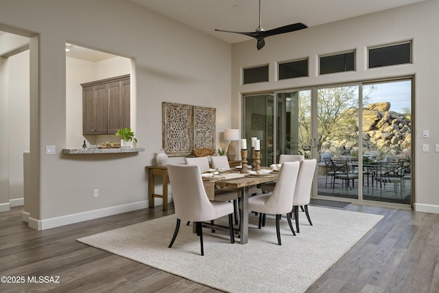 dining space featuring ceiling fan and dark hardwood / wood-style flooring