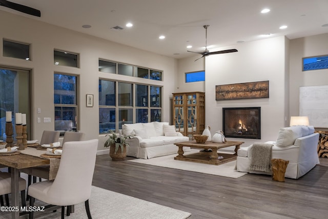 living room with dark wood-type flooring and ceiling fan