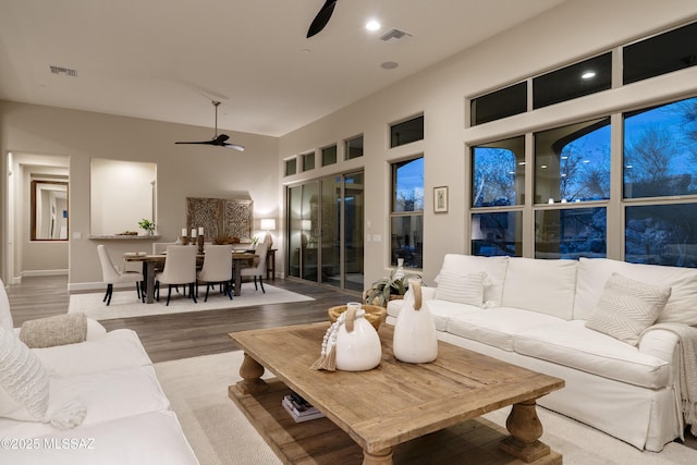 living room featuring ceiling fan and hardwood / wood-style floors